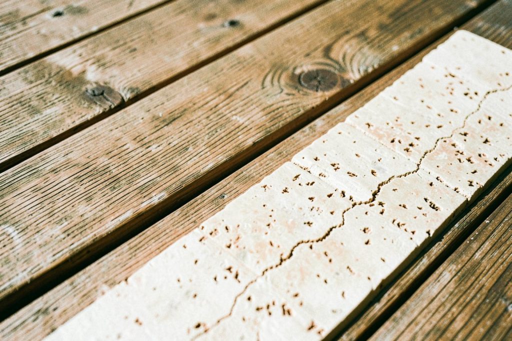 Weathered teak and travertine stone in sunlight